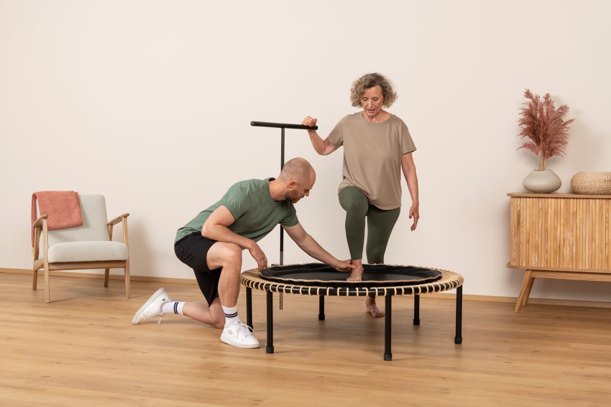 Bellicon rebounder review: Woman jumping on a mini trampoline to build bone density and improve fitness